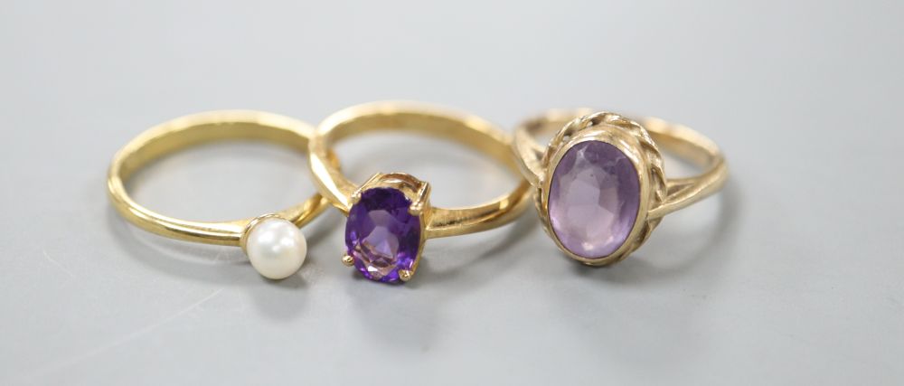 An 18ct gold and pearl ring, a pale amethyst and 9ct gold ring and an amethyst and 18ct gold ring (3)